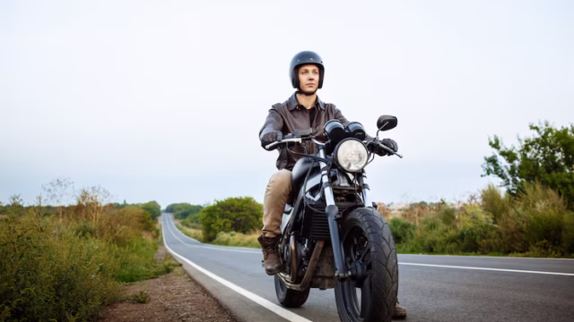young-handsome-man-riding-motorbike-countryside-road_176420-2425